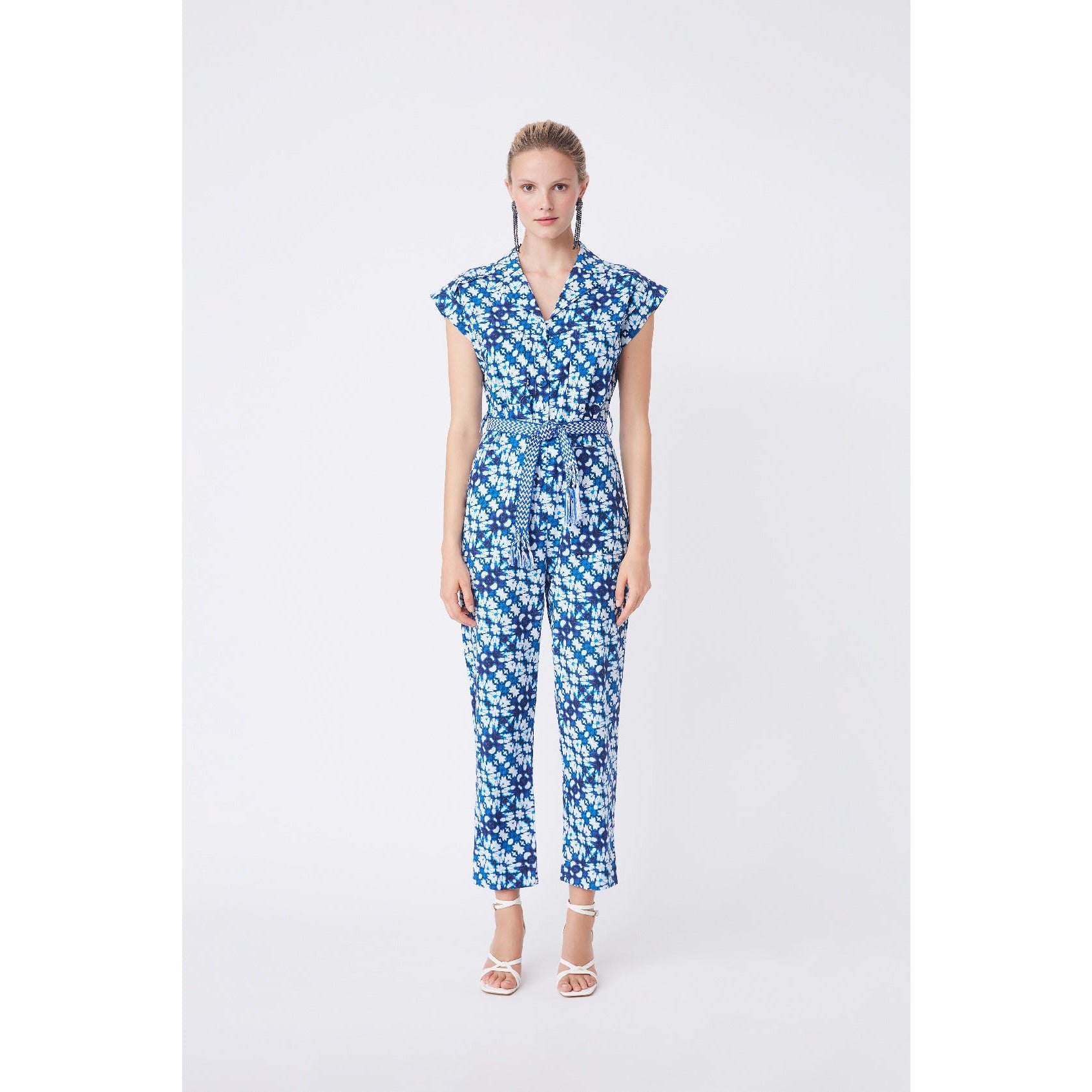 FLORAL BLUE AND WHITE PRINT JUMPSUIT WITH CAP SLEEVES, CONTRASTING TIE AROUND WAIST, LONG TROUSER LEGS